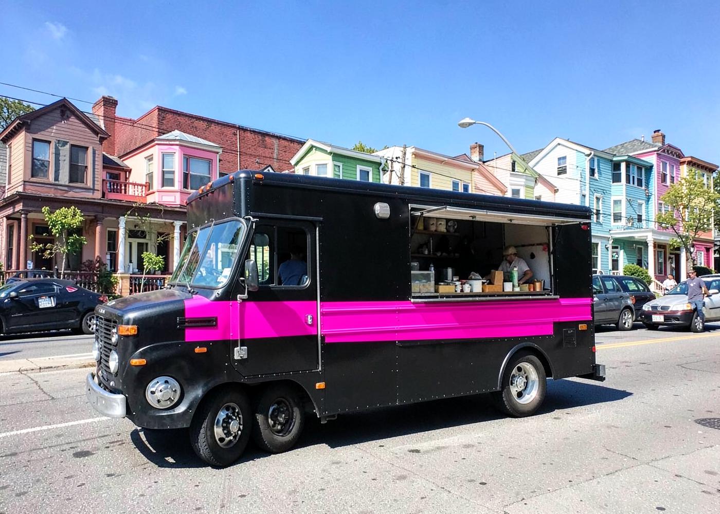 The black Ugly Duckling on Wheels food truck with its serving window open
