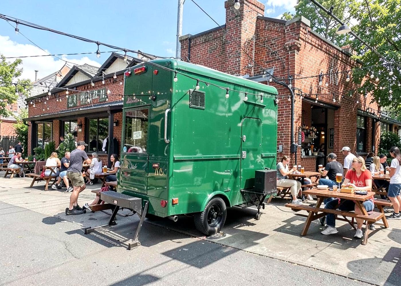 The green Ugly Duckling food truck parked at Rising Tide Brewing in Portland